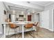 Modern kitchen with island seating, stainless steel appliances, and bright lighting at 300 W 5Th St # 003, Charlotte, NC 28202