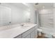 Bathroom with a white vanity, mirror, shower, and toilet at 3077 Light Ridge Sw Ct, Concord, NC 28027