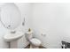 This is a well-lit powder room with a toilet, sink and decorative mirror at 3077 Light Ridge Sw Ct, Concord, NC 28027