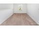 A carpeted bedroom with a window and white walls is well-lit at 3077 Light Ridge Sw Ct, Concord, NC 28027