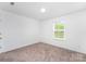 Empty room featuring a window and carpet floors at 3077 Light Ridge Sw Ct, Concord, NC 28027