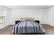 Cozy bedroom featuring a bed with blue striped bedding and two nightstands at 3077 Light Ridge Sw Ct, Concord, NC 28027