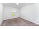 Neutral bedroom with carpet, a window, and simple lighting at 3077 Light Ridge Sw Ct, Concord, NC 28027