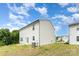Back exterior view with white siding and a grassy area at 3077 Light Ridge Sw Ct, Concord, NC 28027