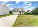 Charming two-story home with a two-car garage and a long driveway, nestled on a partially wooded lot at 3077 Light Ridge Sw Ct, Concord, NC 28027