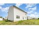 The back of the house with white siding, a grassy yard, and a patio at 3077 Light Ridge Sw Ct, Concord, NC 28027