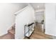 Bright hallway featuring wood-look floors, stairs, and a stylish accent table at 3077 Light Ridge Sw Ct, Concord, NC 28027