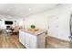 The kitchen features an island with barstool seating, granite countertops, and stainless steel appliances at 3077 Light Ridge Sw Ct, Concord, NC 28027