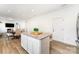 The kitchen features an island with barstool seating, granite countertops, and stainless steel appliances at 3077 Light Ridge Sw Ct, Concord, NC 28027