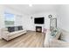 Inviting living room with a cozy fireplace, plank floors, and comfortable seating at 3077 Light Ridge Sw Ct, Concord, NC 28027