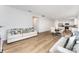 Open-concept living area featuring wood-look floors, a dining area, and a modern kitchen at 3077 Light Ridge Sw Ct, Concord, NC 28027