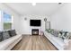 Bright living room with wood-look floors, a cozy fireplace, and comfortable couches at 3077 Light Ridge Sw Ct, Concord, NC 28027
