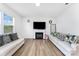 Bright living room with wood-look floors, a cozy fireplace, and comfortable couches at 3077 Light Ridge Sw Ct, Concord, NC 28027