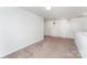 This is a carpeted loft area with several doors and a smooth white wall at 3077 Light Ridge Sw Ct, Concord, NC 28027