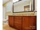 Bathroom with double vanity, granite counters, and a large mirror at 3106 Crosswind Dr, Fort Mill, SC 29707
