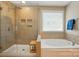 Bathroom featuring a glass-enclosed shower, a soaking tub, and a window for natural light at 3106 Crosswind Dr, Fort Mill, SC 29707