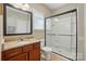 Bathroom featuring a walk-in shower with a glass door and a granite-topped vanity at 3106 Crosswind Dr, Fort Mill, SC 29707