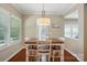 Bright dining area with a modern light fixture, hardwood floors, and large windows providing natural light at 3106 Crosswind Dr, Fort Mill, SC 29707