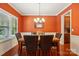 Formal dining room with elegant lighting, wainscoting, and hardwood floors; a perfect setting for meals at 3106 Crosswind Dr, Fort Mill, SC 29707