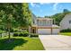 Beautiful home with a well-maintained lawn, mature trees, and a spacious driveway leading to a two-car garage at 3106 Crosswind Dr, Fort Mill, SC 29707