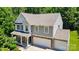 Attractive two-story home featuring gray siding, stone accents, attached garages, and a charming front porch at 3106 Crosswind Dr, Fort Mill, SC 29707