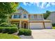 Charming two-story home with stone accents, a two-car garage, and well-manicured landscaping at 3106 Crosswind Dr, Fort Mill, SC 29707