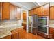 Well-appointed kitchen featuring stainless steel appliances, rich wood cabinetry, and granite countertops at 3106 Crosswind Dr, Fort Mill, SC 29707