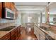 Stylish kitchen with stainless steel appliances, granite countertops, hardwood floors, and a view of the dining area at 3106 Crosswind Dr, Fort Mill, SC 29707