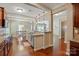 Open-concept kitchen and dining area with an island, granite countertops, stainless steel appliances, and hardwood floors at 3106 Crosswind Dr, Fort Mill, SC 29707