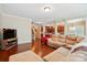 Open-concept living room with hardwood floors, a cozy couch, and views of the kitchen area at 3106 Crosswind Dr, Fort Mill, SC 29707