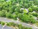 Lush green trees canopy over homes and lawns, creating a serene and private setting with manicured landscaping at 3327 Archdale Dr, Charlotte, NC 28210