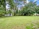 Expansive backyard with lush green grass and a storage shed providing ample outdoor space at 3327 Archdale Dr, Charlotte, NC 28210