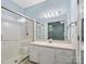 Bright bathroom with glass-enclosed shower, vanity, and large mirror at 3327 Archdale Dr, Charlotte, NC 28210