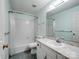 Bright bathroom with a shower-tub combo, a single sink vanity, and white tile at 3327 Archdale Dr, Charlotte, NC 28210