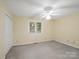 Cozy bedroom featuring neutral walls, carpet, and bright natural light from a window at 3327 Archdale Dr, Charlotte, NC 28210