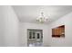 Dining room with decorative chandelier and open view to a bright sunroom and kitchen space at 3327 Archdale Dr, Charlotte, NC 28210