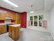 Charming kitchen featuring wood cabinets, island, and natural light from a bright window at 3327 Archdale Dr, Charlotte, NC 28210