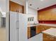 Kitchen featuring wood cabinets, and modern appliances, creating an efficient cooking space at 3327 Archdale Dr, Charlotte, NC 28210
