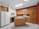 Efficient kitchen layout featuring ample cabinetry, center island, and modern appliances at 3327 Archdale Dr, Charlotte, NC 28210