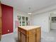 View of a kitchen island with wooden cabinets and large windows at 3327 Archdale Dr, Charlotte, NC 28210