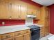 Charming kitchen features wooden cabinetry, laminate countertops, and vintage appliances at 3327 Archdale Dr, Charlotte, NC 28210