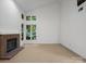 Bright living room with fireplace and multiple large windows, offering views and natural light at 3327 Archdale Dr, Charlotte, NC 28210