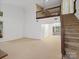 Spacious living room with high ceilings, staircase and natural light, showcasing an open layout for entertaining and relaxation at 3327 Archdale Dr, Charlotte, NC 28210