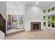 Bright living room with fireplace, high ceilings, and many windows offering natural light at 3327 Archdale Dr, Charlotte, NC 28210