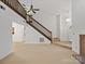Open floorplan with staircase leading to the upper level, adjacent to a comfortable living area at 3327 Archdale Dr, Charlotte, NC 28210