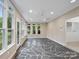 Lovely sunroom with mosaic stone flooring and ample windows with views of exterior at 3327 Archdale Dr, Charlotte, NC 28210