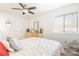 Bright bedroom featuring a ceiling fan, neutral color palette, and a large window at 3615 Maple Glenn Ln, Charlotte, NC 28226