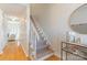 Bright foyer with hardwood floors, staircase and decor table with mirror at 3615 Maple Glenn Ln, Charlotte, NC 28226