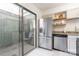 Stainless steel refrigerator and dishwasher in a bright kitchen overlooking private patio at 3615 Maple Glenn Ln, Charlotte, NC 28226