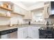 Updated kitchen with stainless steel appliances, open shelving, and granite counters at 3615 Maple Glenn Ln, Charlotte, NC 28226